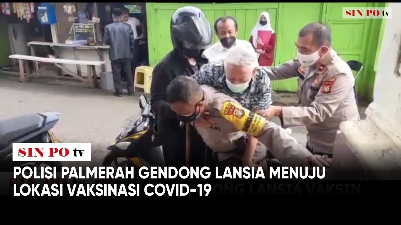 Polisi Palmerah Gendong Lansia Menuju Lokasi Vaksinasi Covid-19